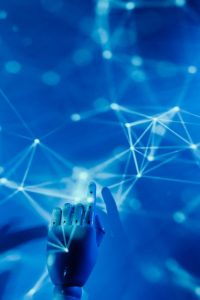 Futuristic robotic hand touching a digital network on a blue background