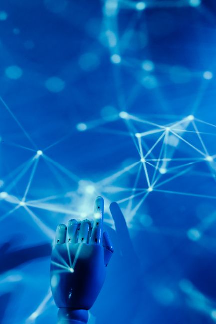 Futuristic robotic hand touching a digital network on a blue background